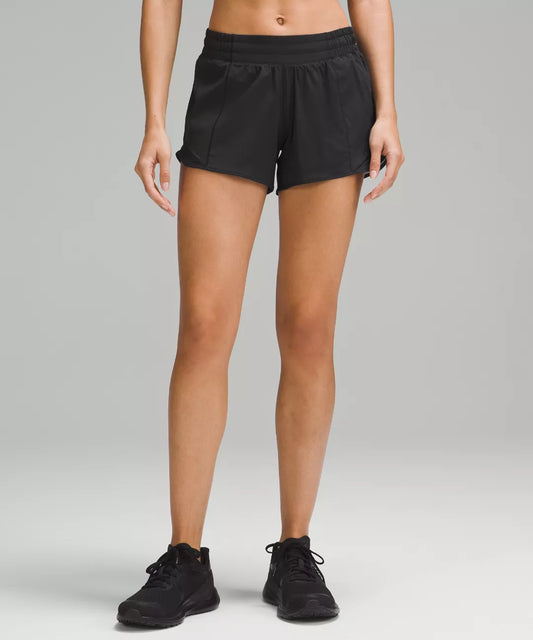 Person wearing black shorts on a gray background
