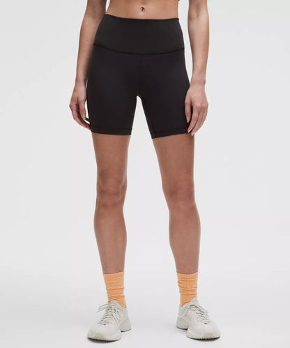 Person wearing black athletic shorts on a white background