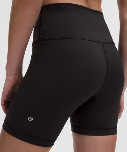 Black athletic shorts with a brand logo on a neutral background