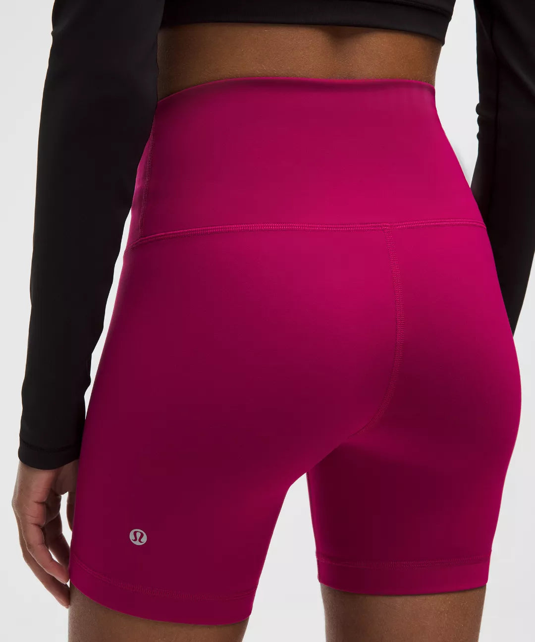 Pink athletic shorts with a brand logo on a white background