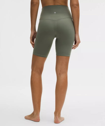 Person wearing green athletic shorts on a white background