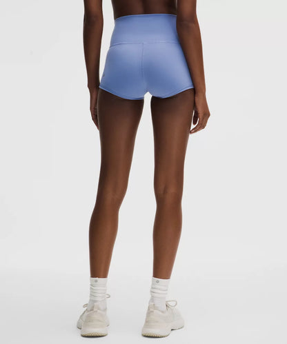 Person wearing blue athletic shorts on a white background