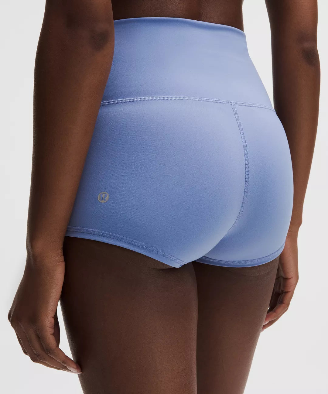 Light blue athletic shorts worn by a person on a white background