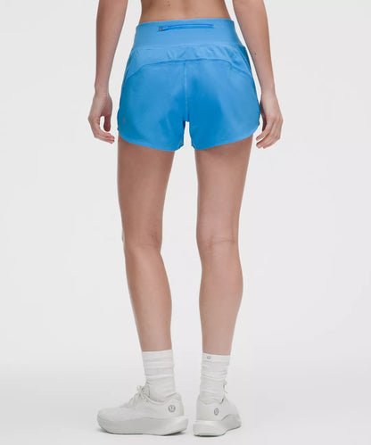 Person wearing blue athletic shorts on a white background
