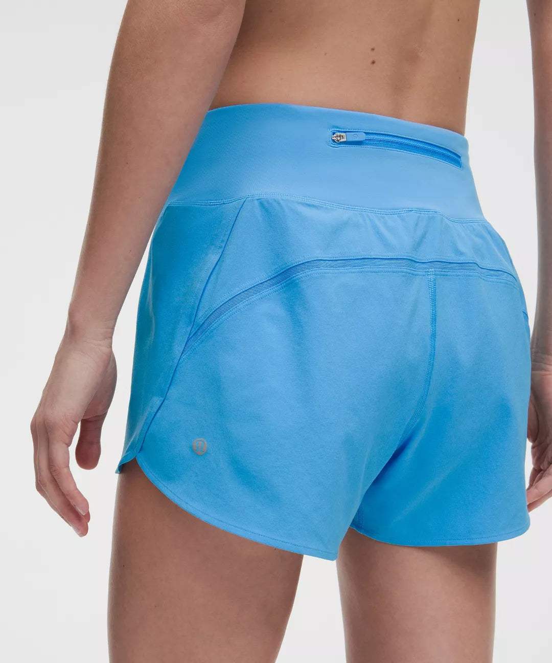 Blue athletic shorts worn by a person on a white background