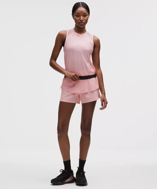 Woman wearing a pink athletic outfit on a white background