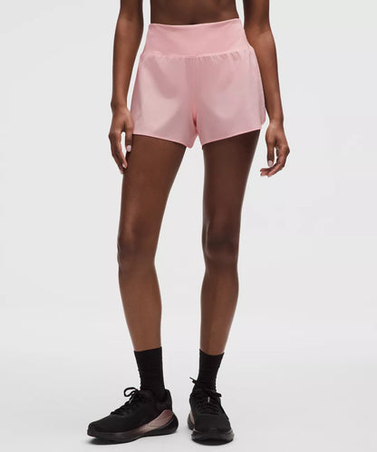 Person wearing pink shorts on a white background
