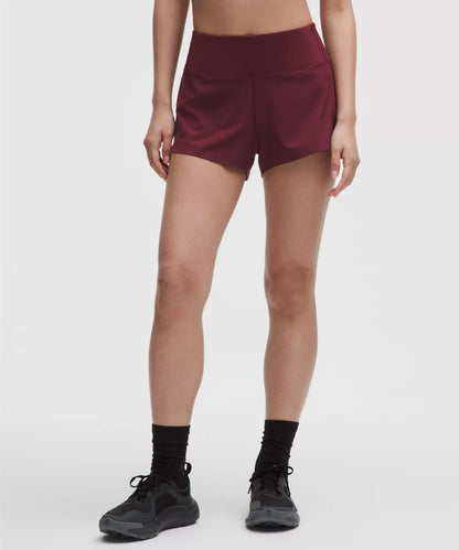Maroon athletic shorts worn by a person on a white background