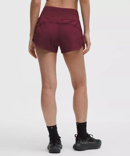 Maroon athletic shorts worn by a person on a white background