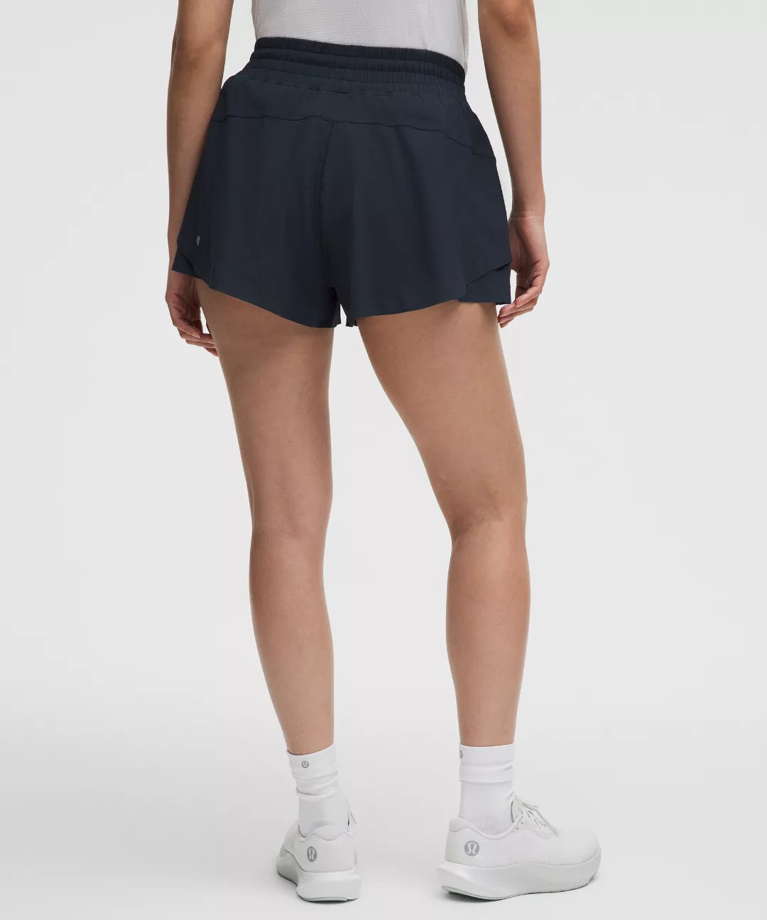 Person wearing navy shorts on a white background