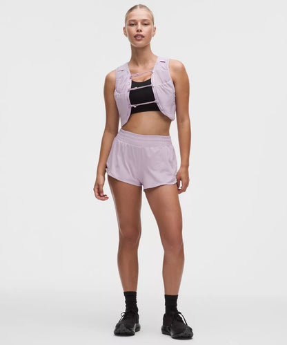 Woman wearing a light purple athletic outfit on a white background