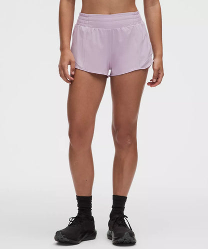 Person wearing light purple shorts on a white background