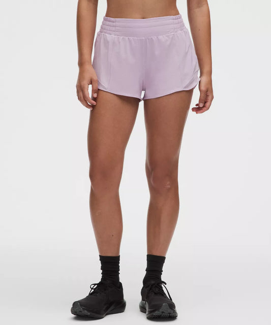 Person wearing light purple shorts on a white background