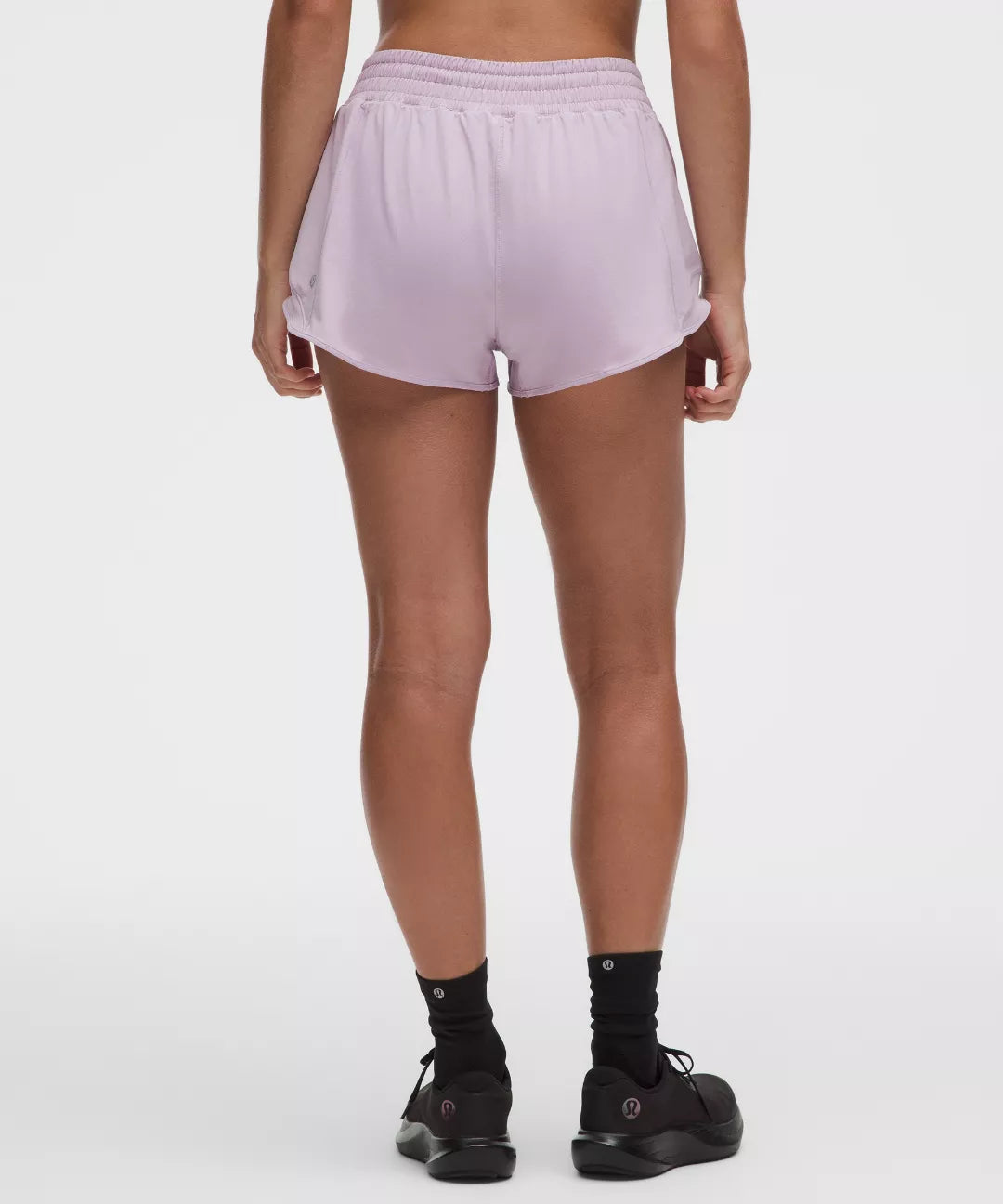 Person wearing light purple shorts on a white background