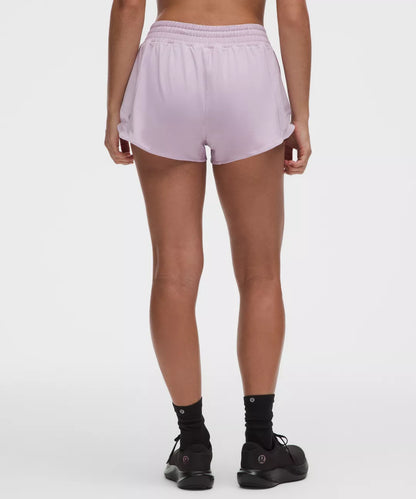 Person wearing light purple shorts on a white background