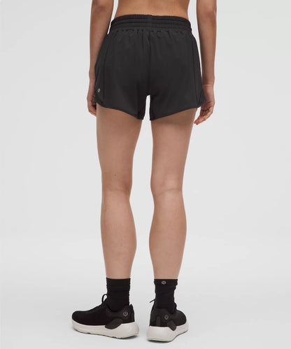 Person wearing black athletic shorts on a white background