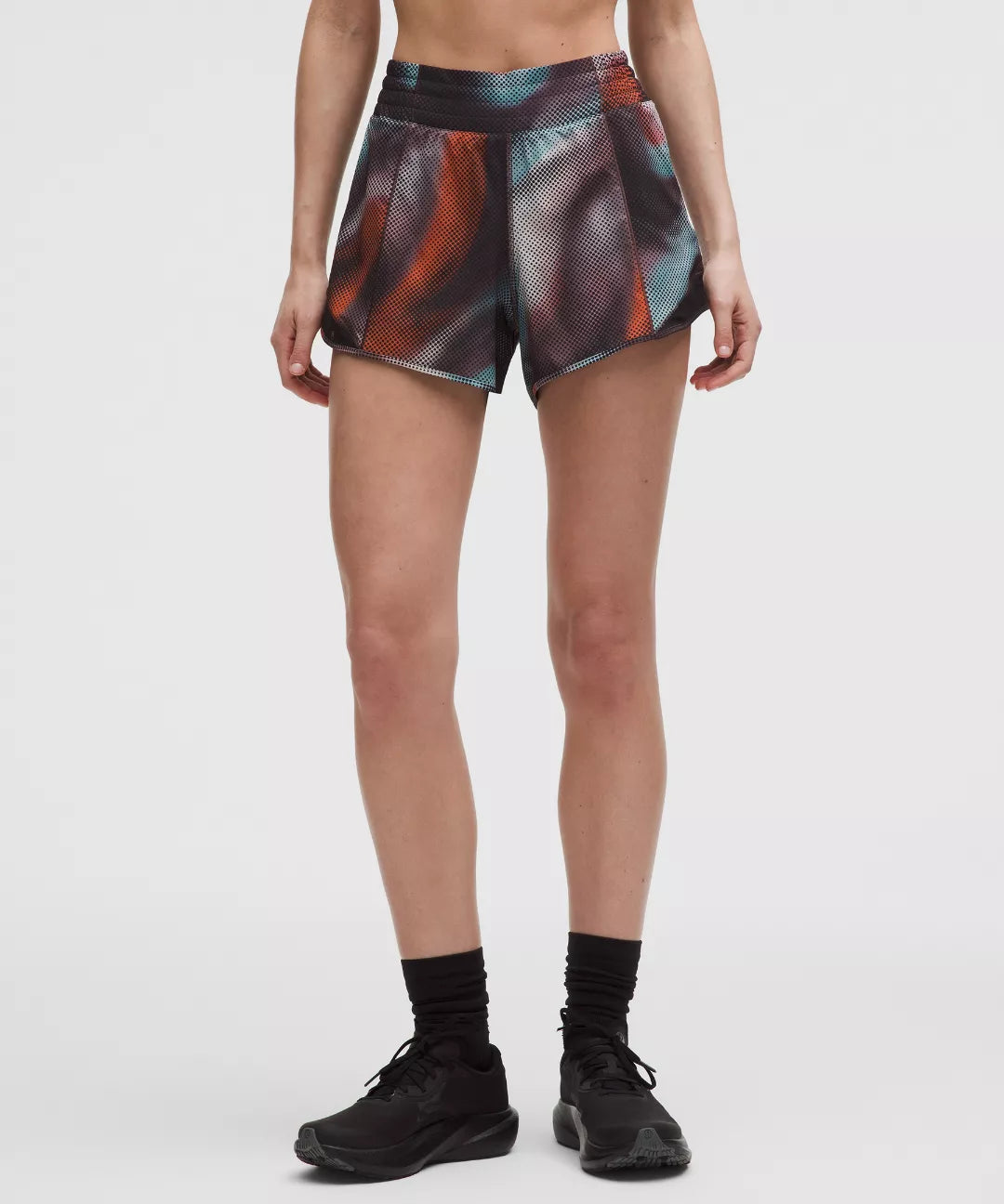 Person wearing patterned shorts on a white background