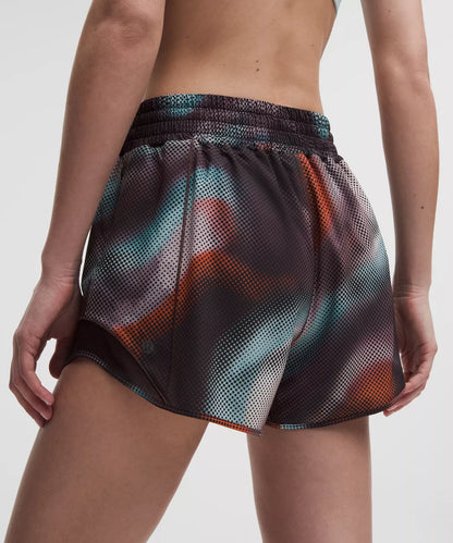 Multicolored mesh shorts worn by a person on a white background