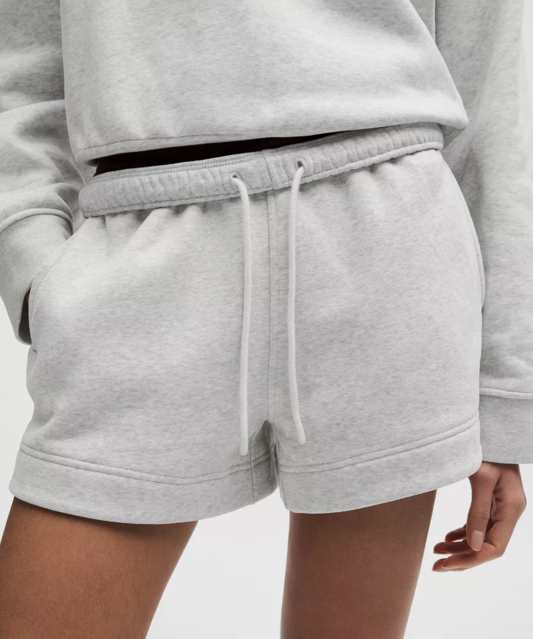 Gray sweatshirt and shorts set on a plain background