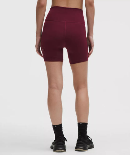 Maroon athletic shorts worn by a person on a white background