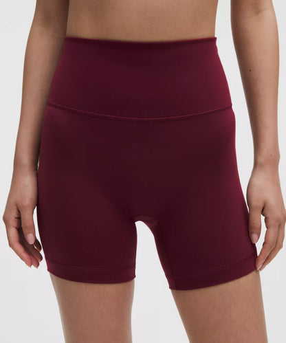 Maroon athletic shorts worn by a person on a white background