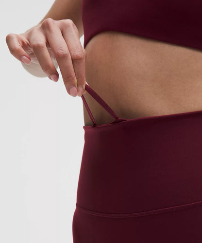 Maroon athletic outfit with a focus on the waistband against a neutral background