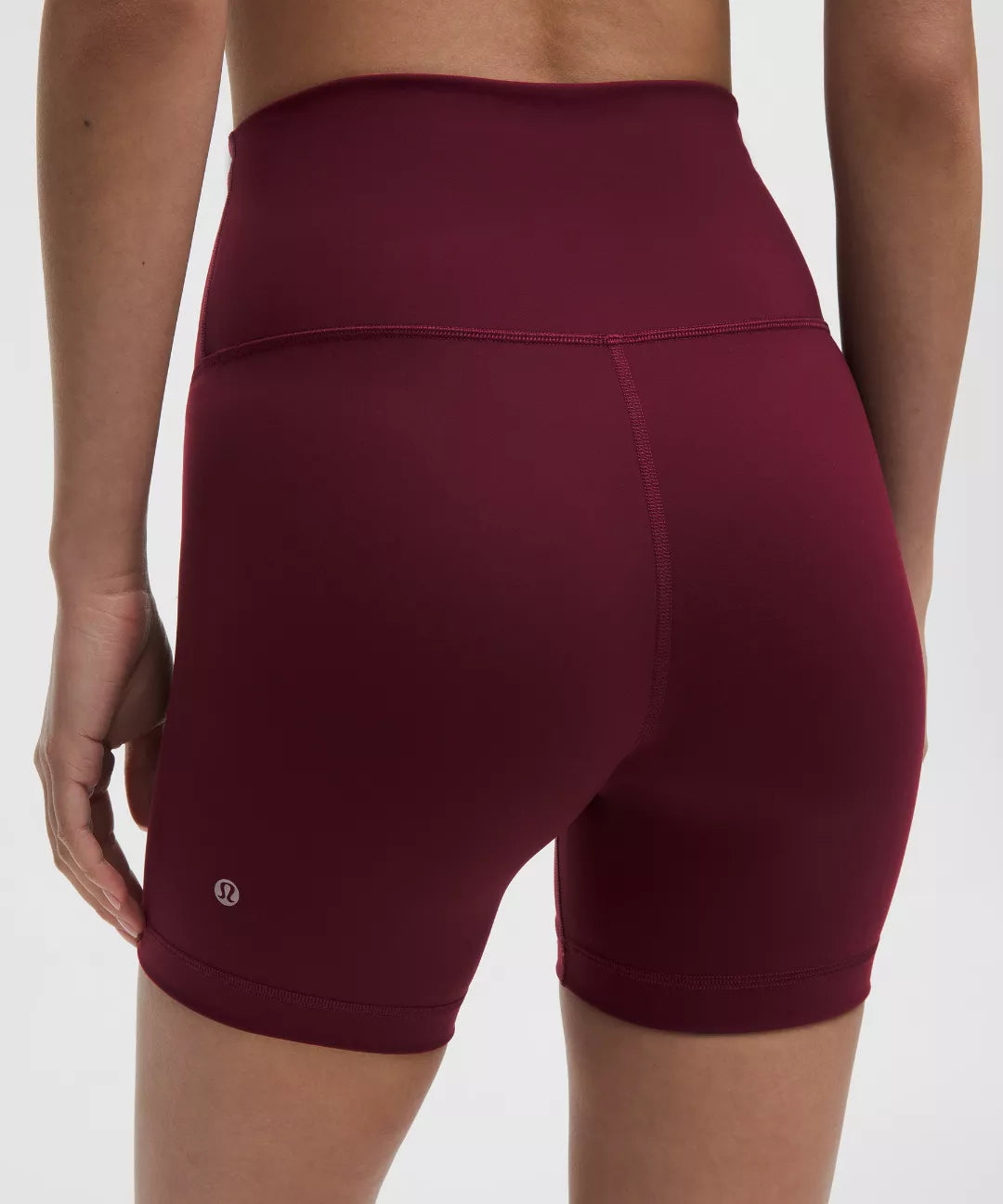 Maroon athletic shorts worn by a person on a white background