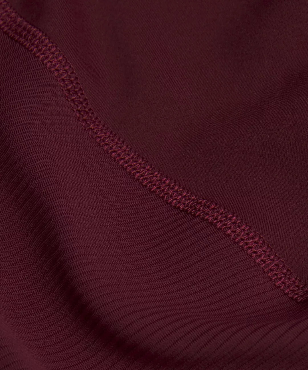 Close-up of a maroon fabric with a textured edge