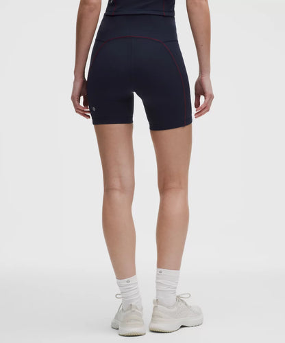 Person wearing black athletic shorts on a white background