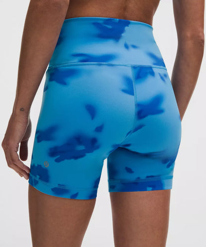 Blue patterned shorts worn by a person on a white background
