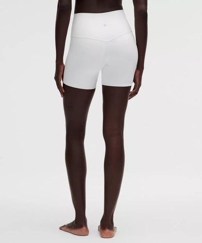 White athletic shorts worn by a person on a white background