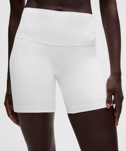 White athletic shorts worn by a person on a white background