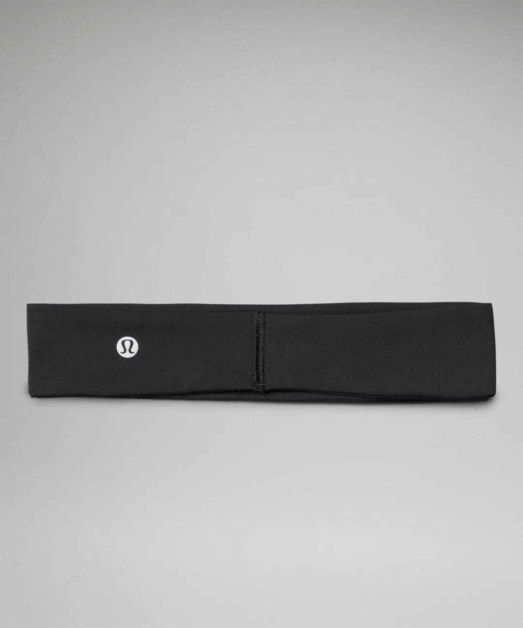 Black headband with a logo on a gray background