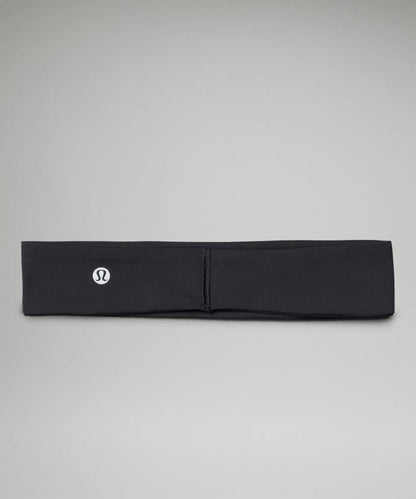 Black headband with a logo on a gray background