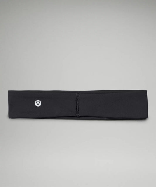 Black headband with a logo on a gray background